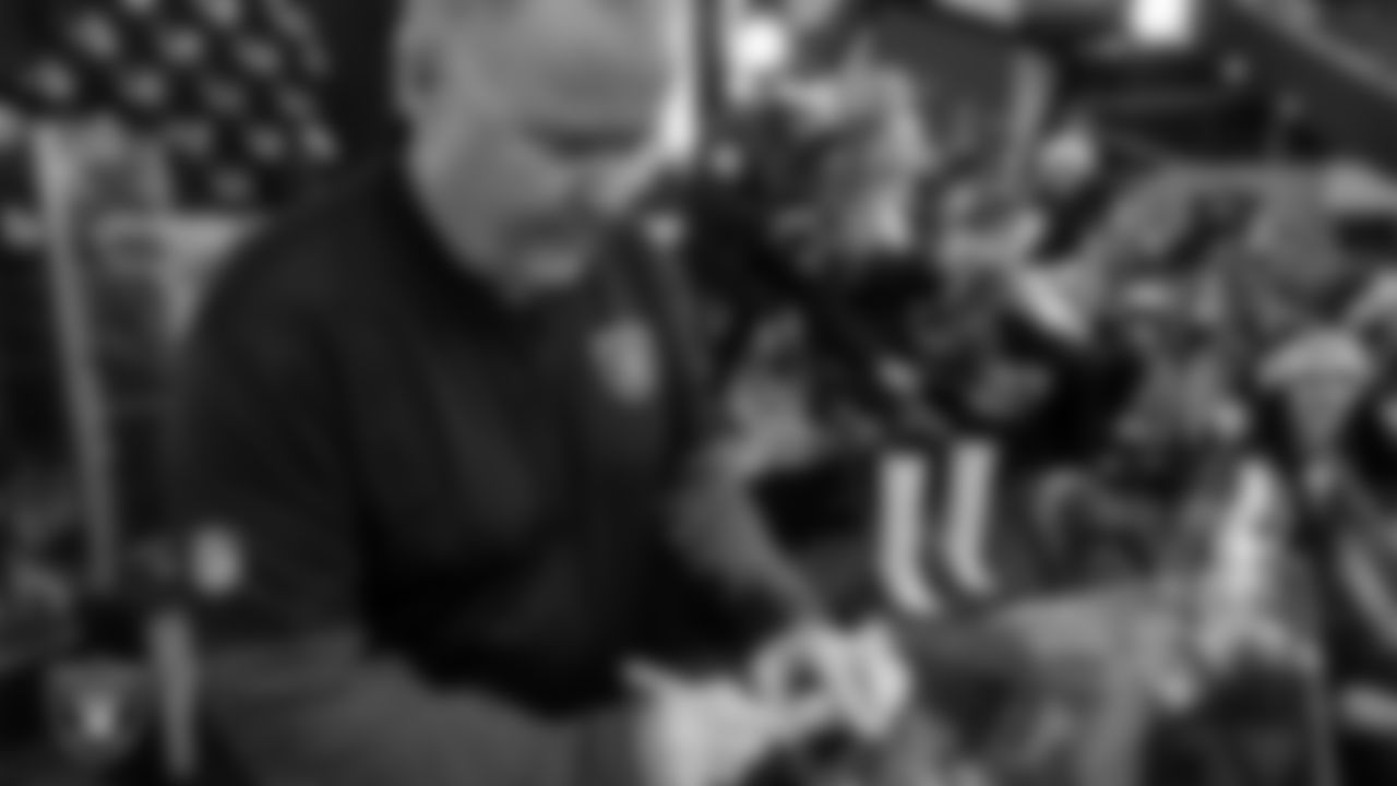 Las Vegas Raiders host of Raider Nation Radio JT the Brick signs a plaque for the Al Davis Memorial torch before the Las Vegas Raiders' regular season home game against the New York Giants at Allegiant Stadium.