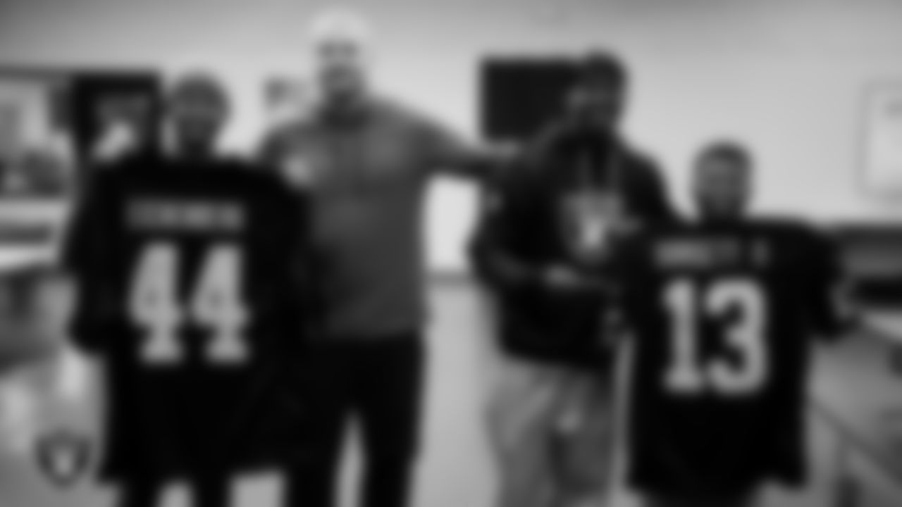 Las Vegas Raiders linebacker Tommy Eichenberg (44) and wide receiver Phillip Dorsett II (13) pose for a photo with members of the Boys and Girls Club at the Lied Memorial Boys & Girls Clubs of Southern Nevada.