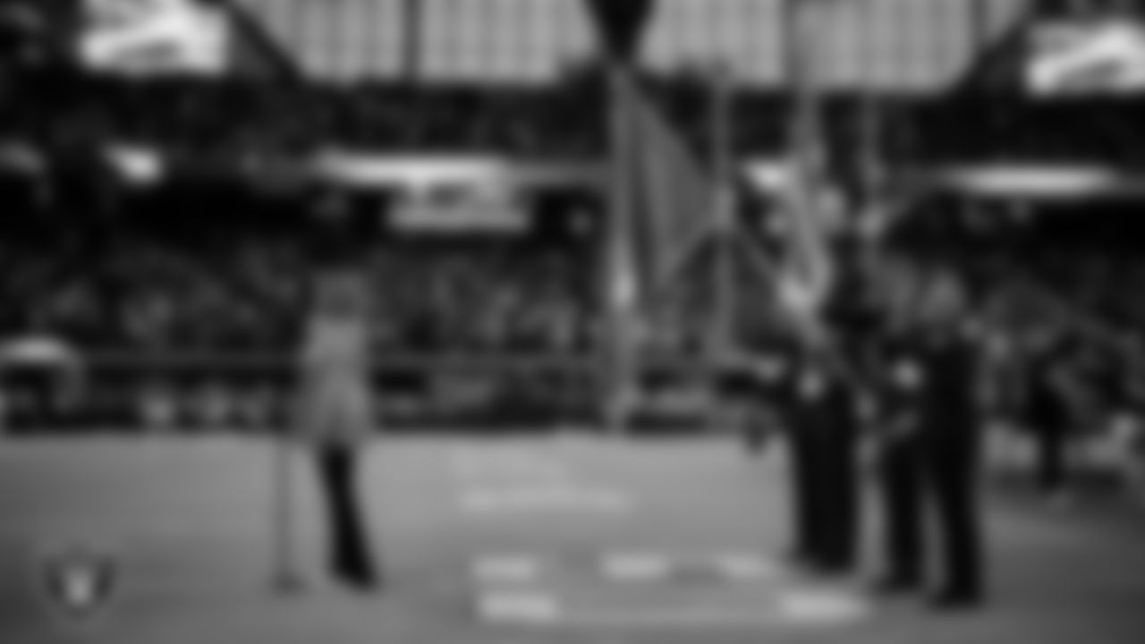 Singer Lalah Hathaway performs the national anthem, while Rancho High School Junior ROTC presents the nation's colors, before the Las Vegas Raiders' preseason home game against the Dallas Cowboys at Allegiant Stadium.