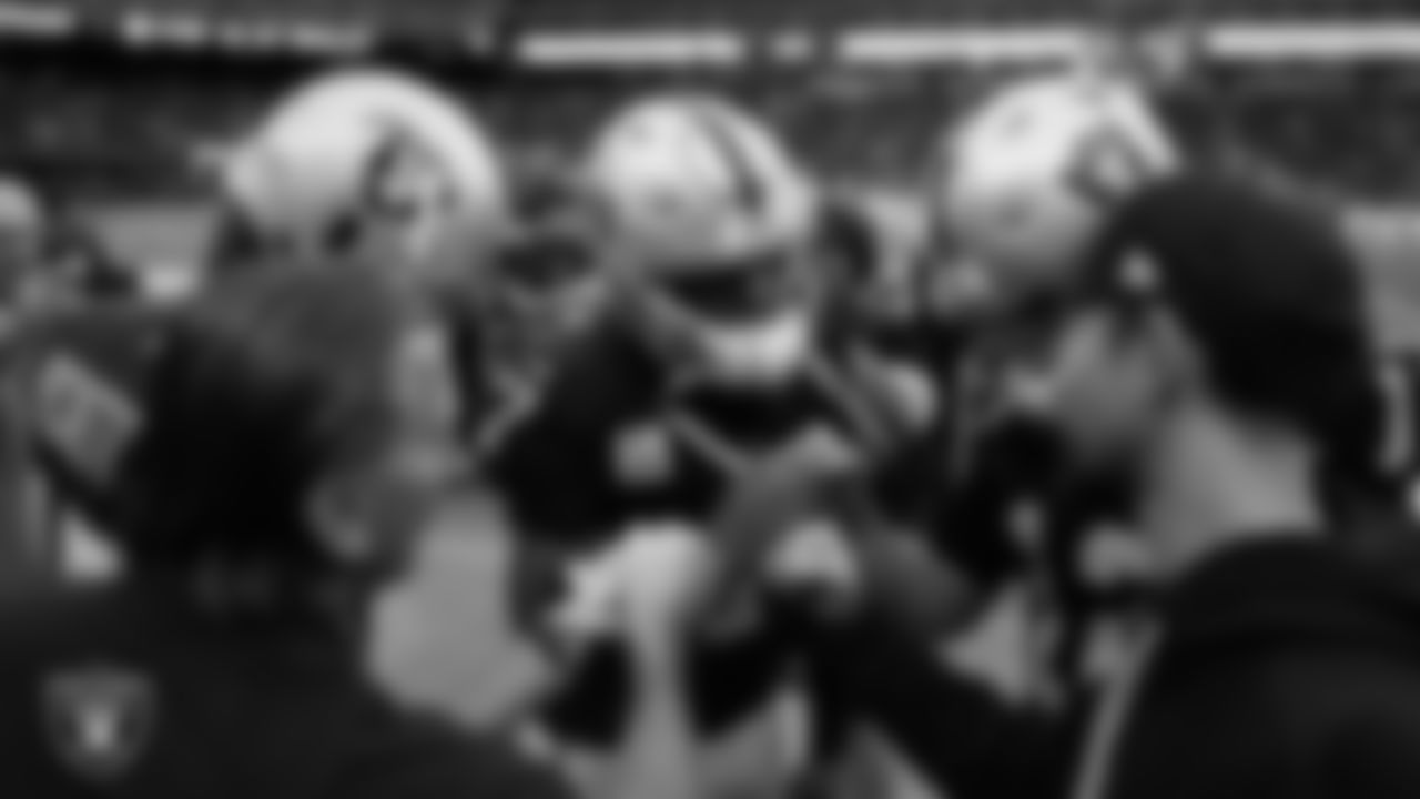 The Las Vegas Raiders quarterbacks huddle before the regular season home game against the Cleveland Browns at Allegiant Stadium.