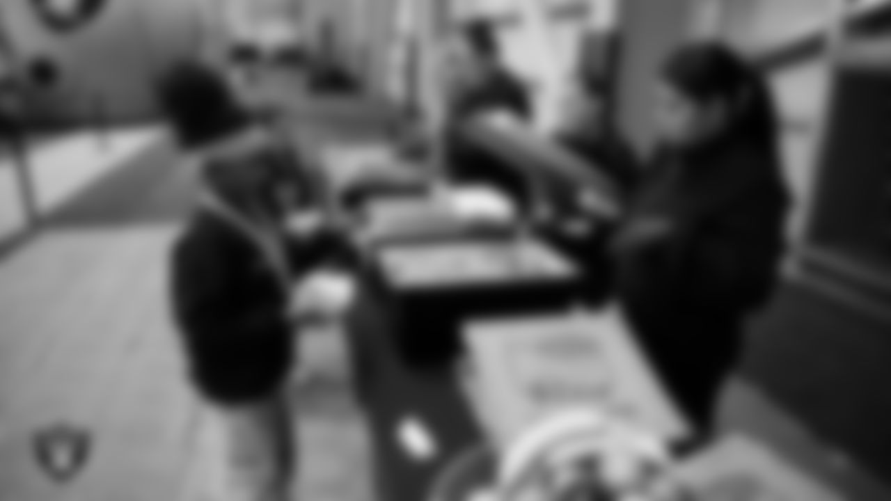 Students grab food during a Raiders Youth Holiday Party at Intermountain Health Performance Center.