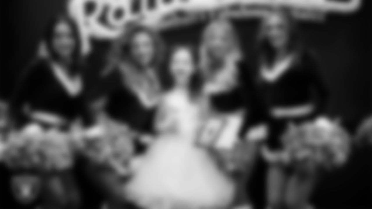 Raiderettes pose for a photo with a Junior Raiderette during the Junior Raiderettes Banquet at The Studio.