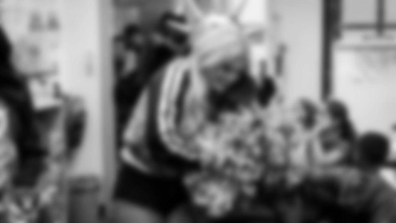 Raiderette Pip hugs a student during a 'Lil Raiders Pop-Up at Richard H. Bryan Elementary School.