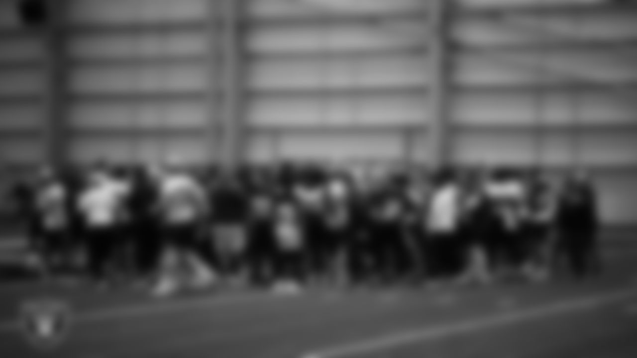 The Las Vegas Raiders huddle at a workout during phase two of the offseason program at Intermountain Health Performance Center.