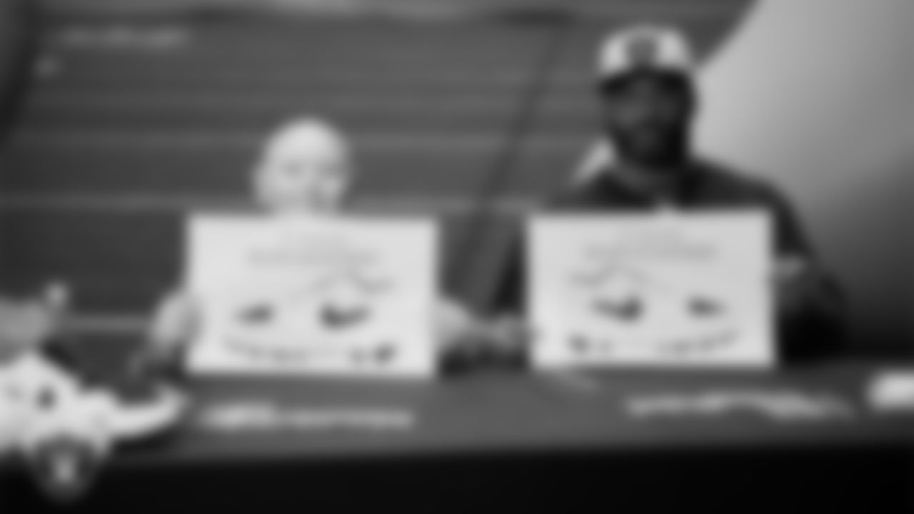 Las Vegas Raiders linebacker Elandon Roberts (52) and  Intermountain Children's Health patient Isaak show off their My Cause My Cleats custom shoes design at Intermountain Health Performance Center.