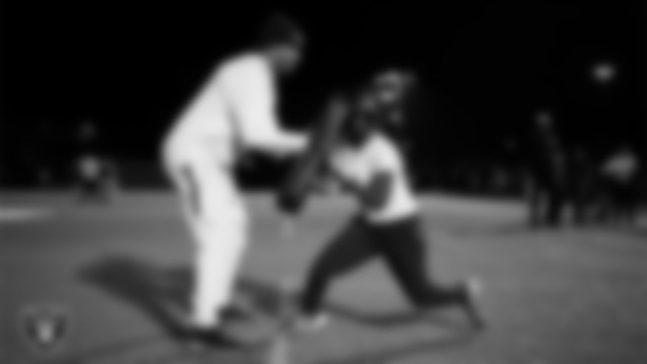 An athlete takes part in a Silver and Black League flag football clinic at Bill and Lillie Heinrich YMCA.