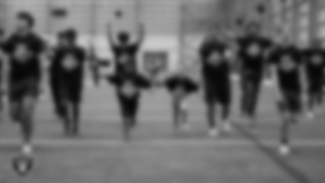 Athletes warmup during Raiders ELITE Academy at Las Vegas Raiders Headquarters.
