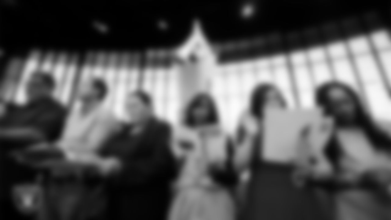 New citizens recite the Pledge of Allegiance during a Naturalization Ceremony at Allegiant Stadium.