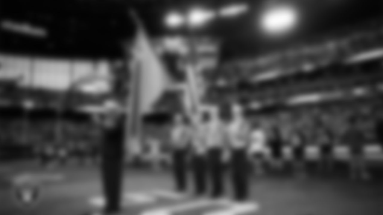 Retired Navy officer and singer Generald Wilson performs the national anthem, while the Centennial High School Navy JROTC Color Guard presents the nation's colors, before the Las Vegas Raiders' regular season home game against the Tennessee Titans at Allegiant Stadium.