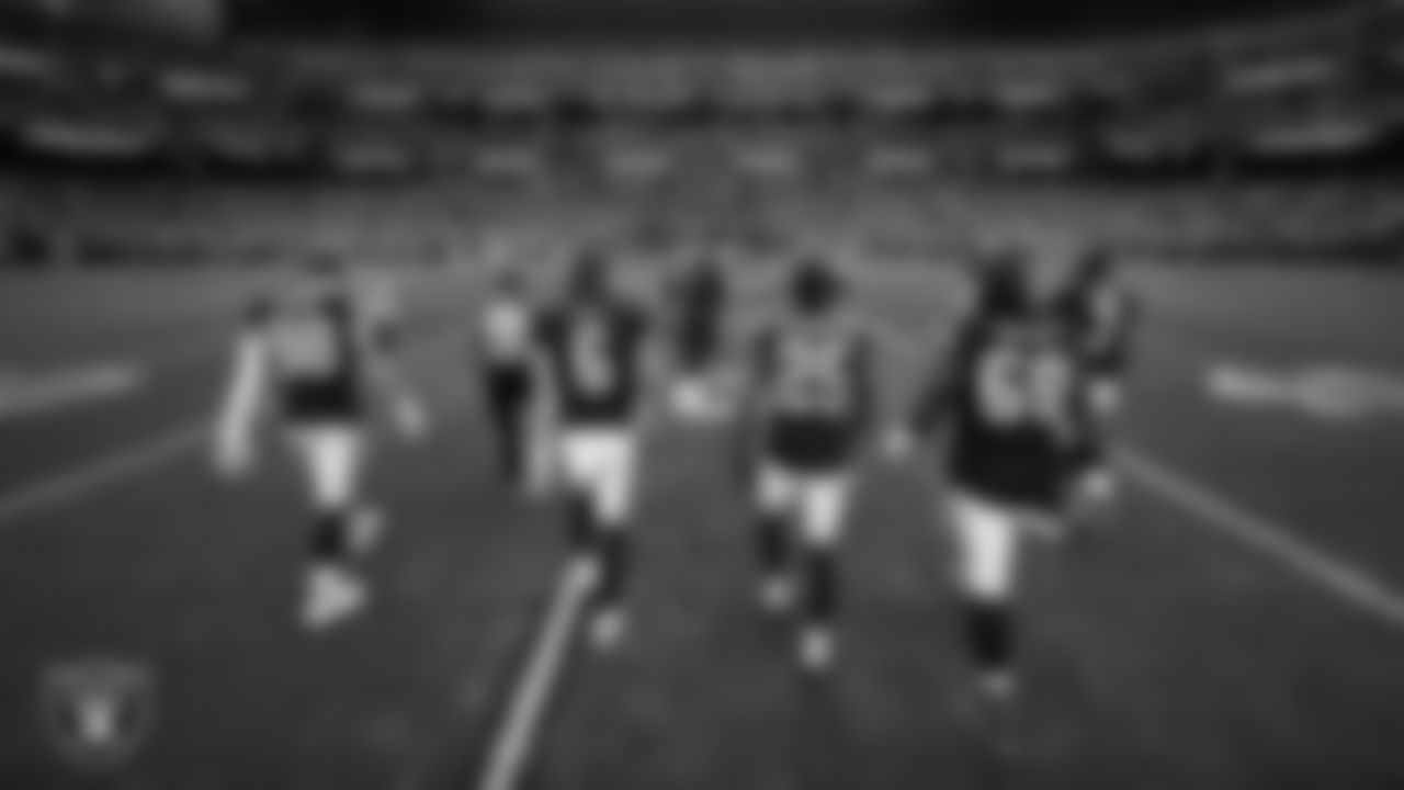 The Las Vegas Raiders walk out to the center of the field for the coin toss before the regular season home game against the the Denver Broncos at Allegiant Stadium.