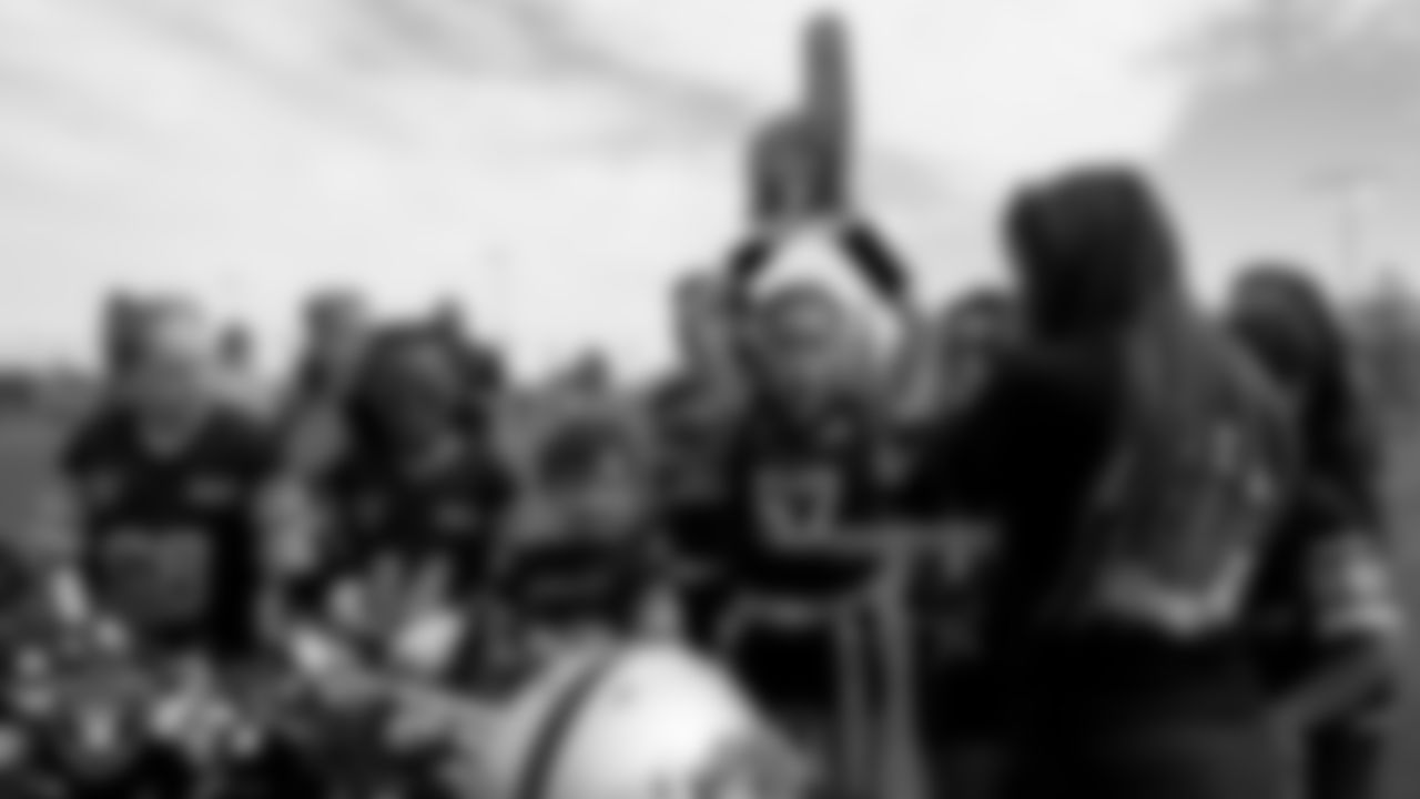 Athletes receive Las Vegas Raiders gear during Silver and Black Saturday at McCarran Marketplace Park.