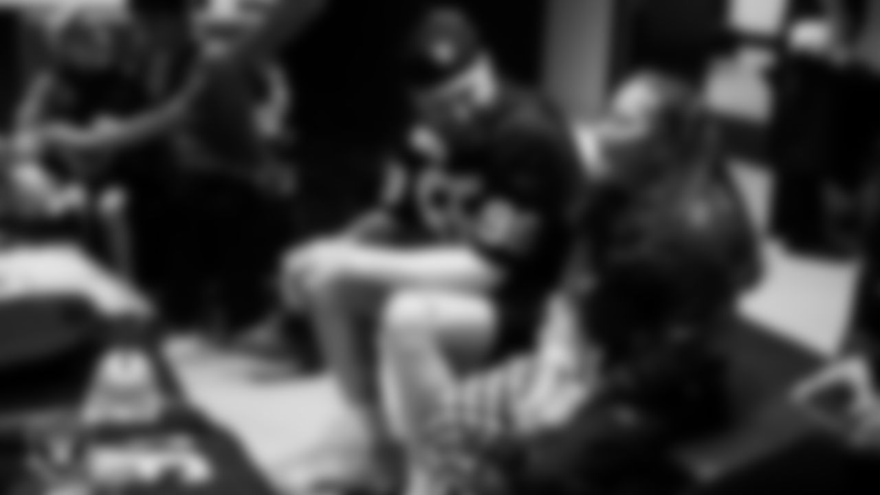 Las Vegas Raiders defensive end Maxx Crosby (98) speaks with Intermountain Children's Health patient Luna at Intermountain Health Performance Center.