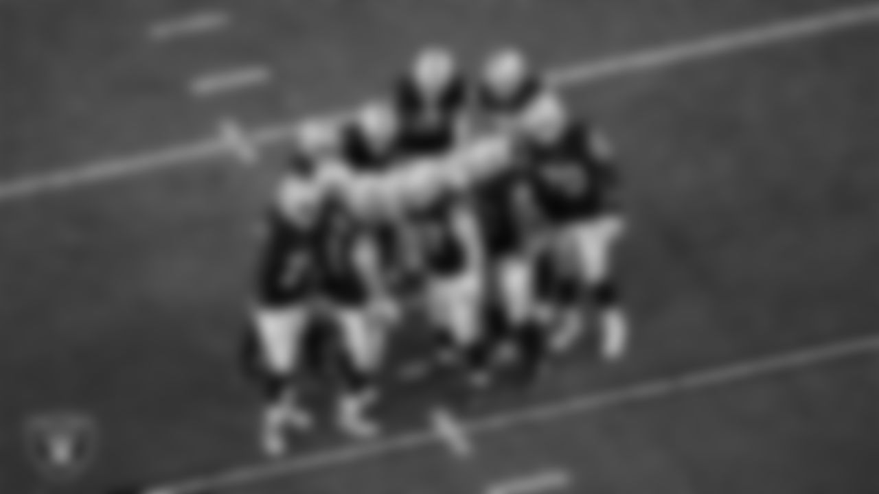 The Las Vegas Raiders offense huddles during the regular season home game against the Dallas Cowboys at Allegiant Stadium.