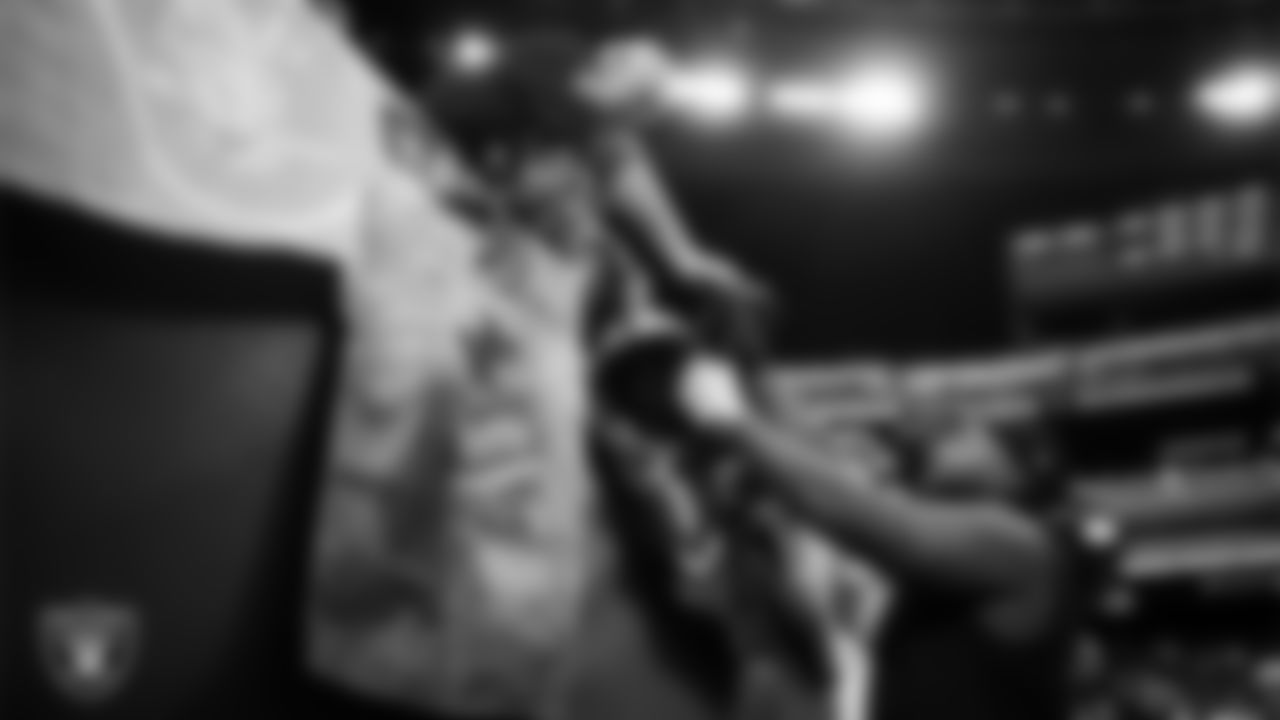 Las Vegas Raiders defensive tackle Adam Butler (69) signs autographs for fans before the regular season home game against the Denver Broncos at Allegiant Stadium.