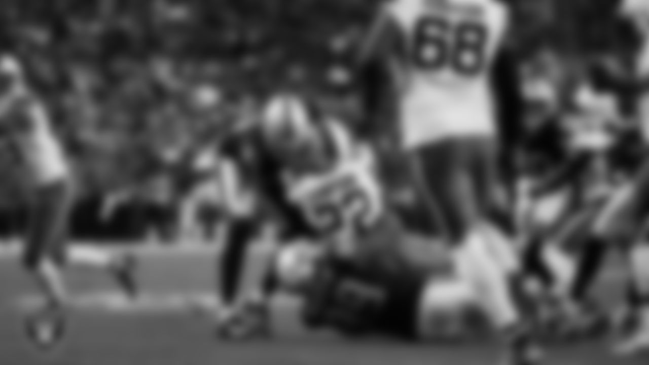 Las Vegas Raiders defensive end Malcolm Koonce (51) and defensive tackle Thomas Booker IV (99) make a tackle during the regular season home game against the Cleveland Browns at Allegiant Stadium.