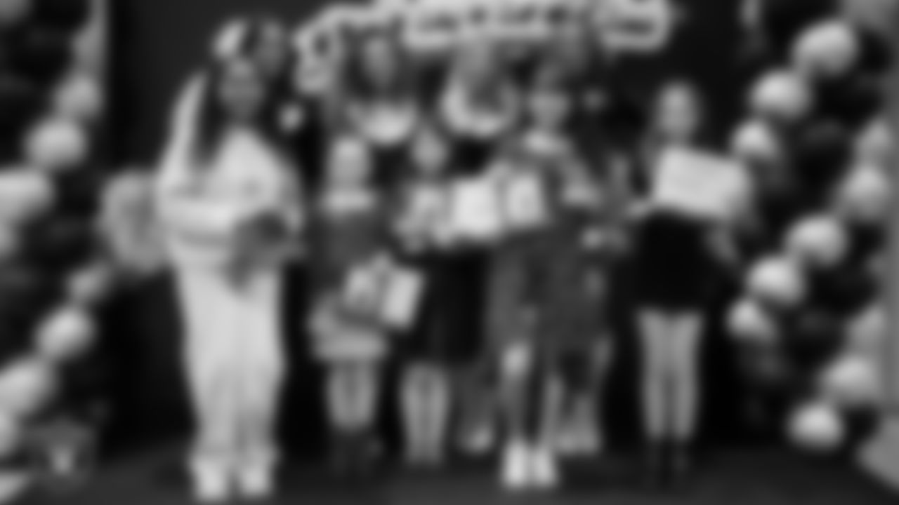 Raiderettes pose for a photo with Junior Raiderettes during the Junior Raiderettes Banquet at The Studio.