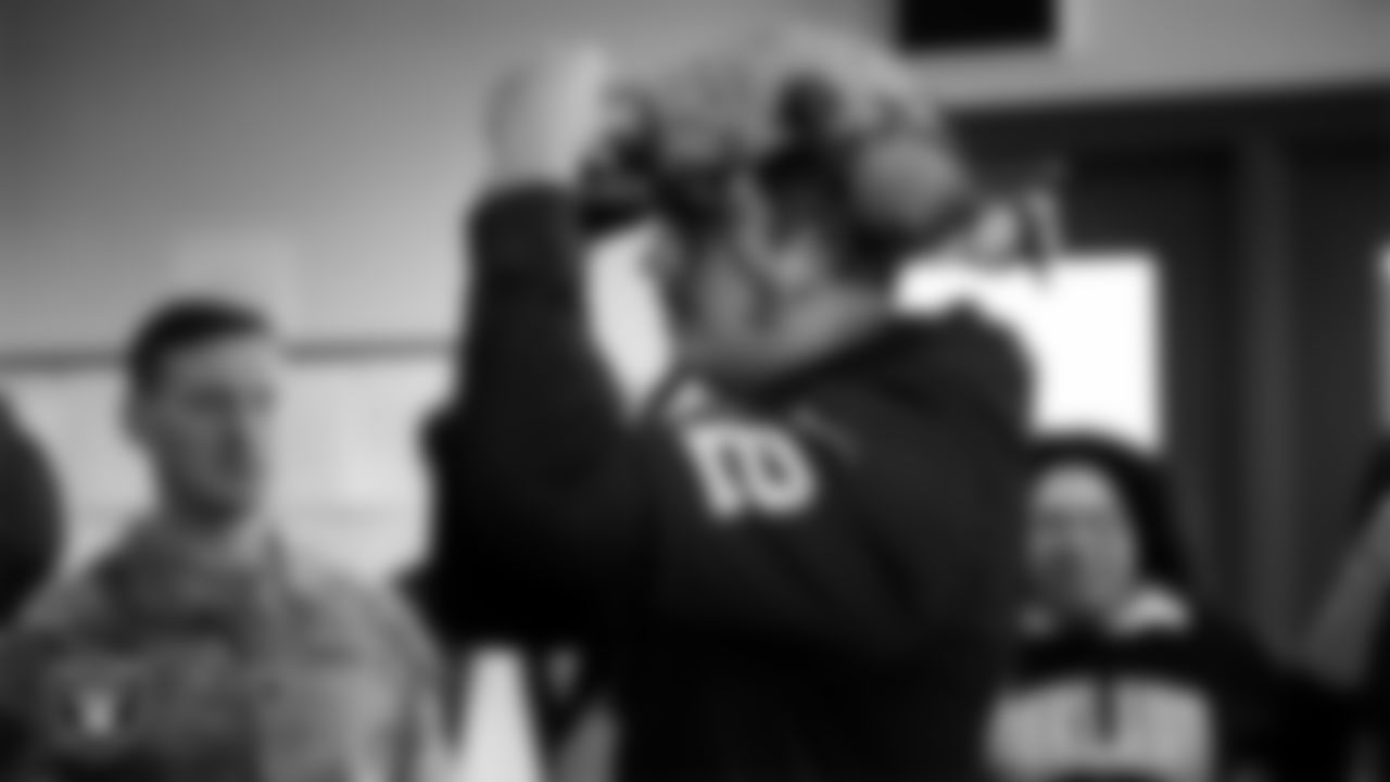 Las Vegas Raiders quarterback Aidan O'Connell (12) tries on military equipment during a tour of Nellis Air Force Base.