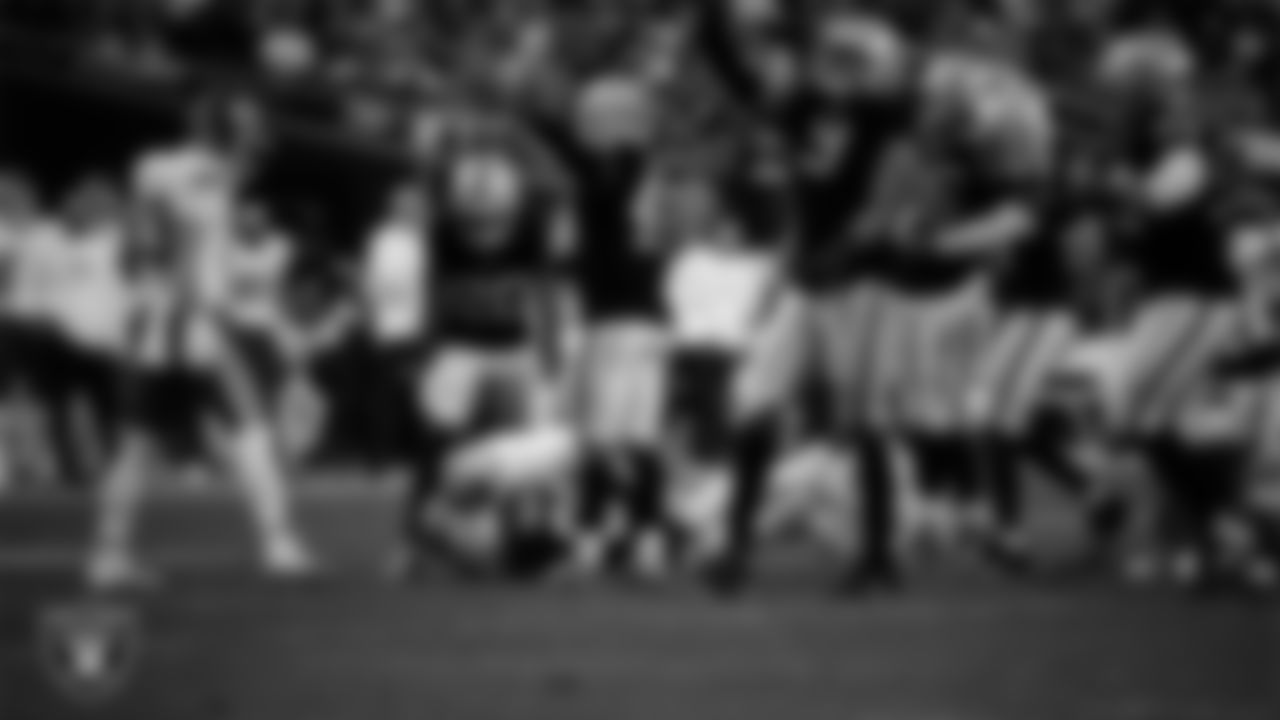 Las Vegas Raiders cornerback Darien Porter (26) recovers a fumble during the regular season home game against the Kansas City Chiefs at Allegiant Stadium.
