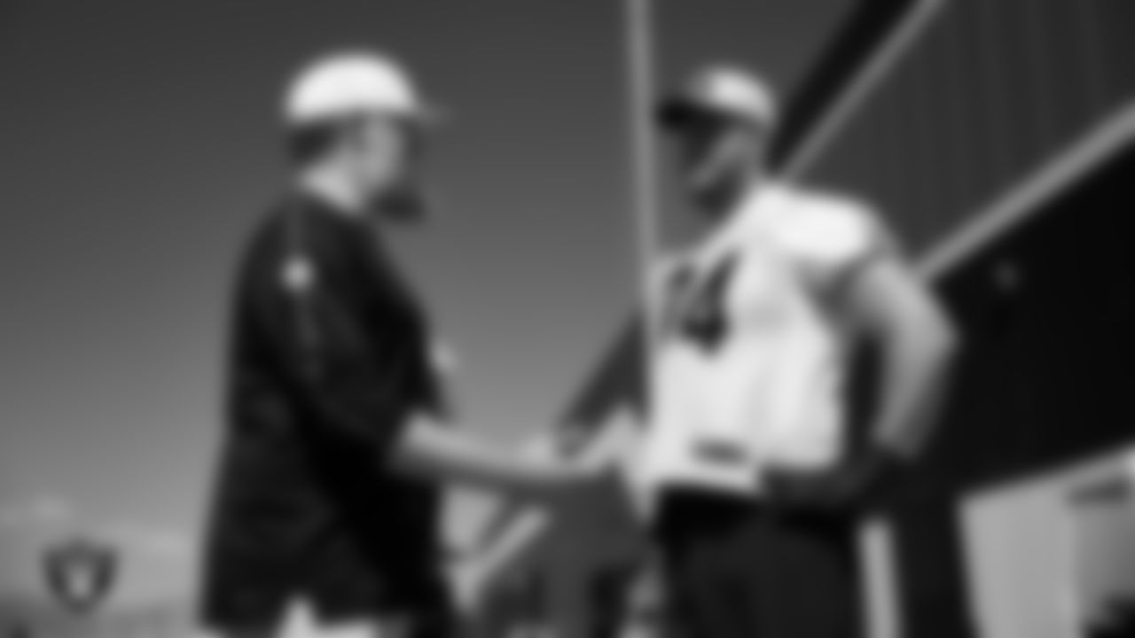 Las Vegas Raiders run game coordinator/offensive line coach Brennan Carroll and tackle Kolton Miller (74) at a workout during phase two of the offseason program at Intermountain Health Performance Center.