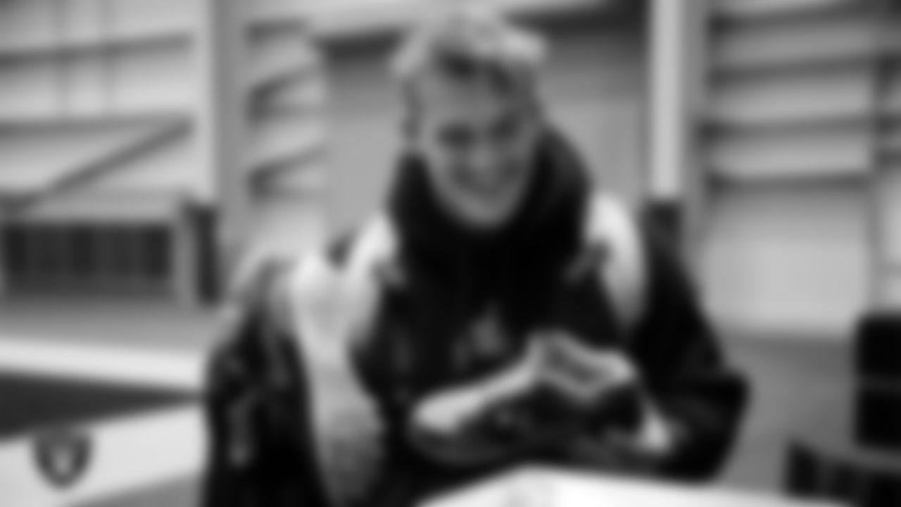 Las Vegas Raiders linebacker Cody Lindenberg (55) unboxes his custom cleats for the NFL's My Cause My Cleats initiative at Intermountain Health Performance Center.