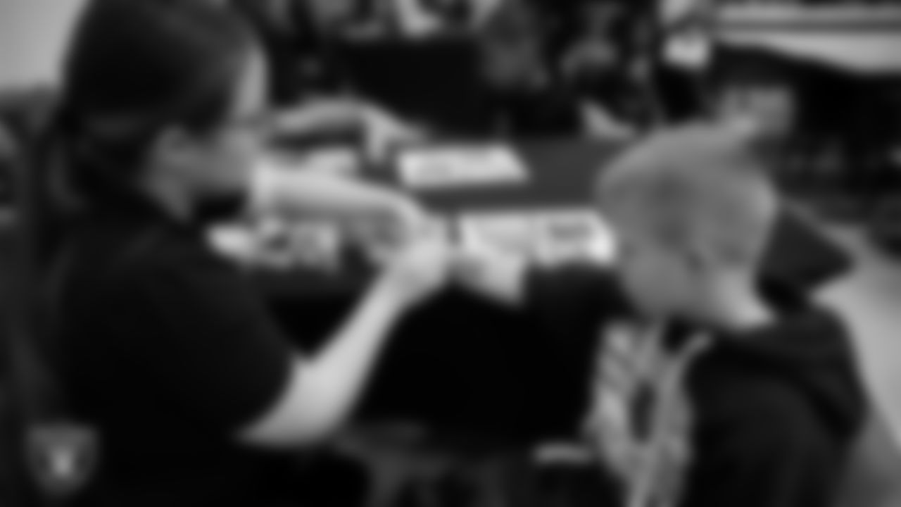 A student gets a Raiders tattoo during a Raiders Spirit Day at Richard H. Bryan Elementary School.