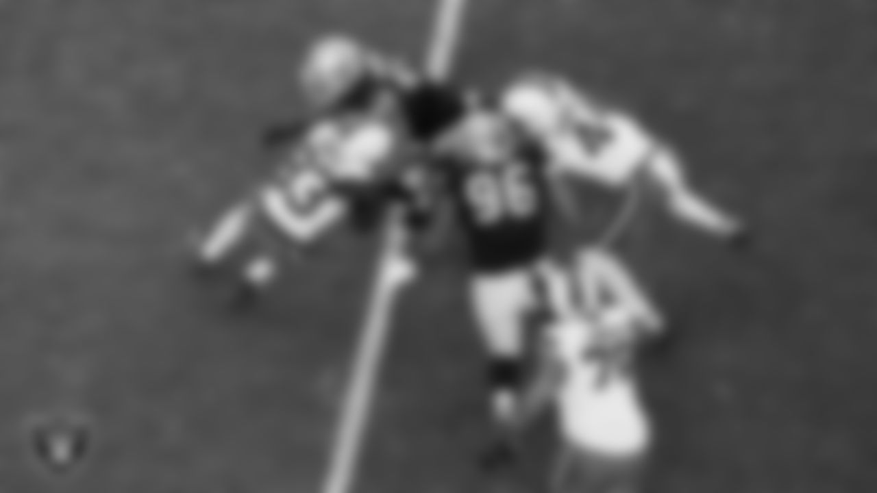 Las Vegas Raiders defensive end Charles Snowden (49) and defensive tackle Jonah Laulu (96) go to make a tackle during the regular season home game against the Cleveland Browns at Allegiant Stadium.