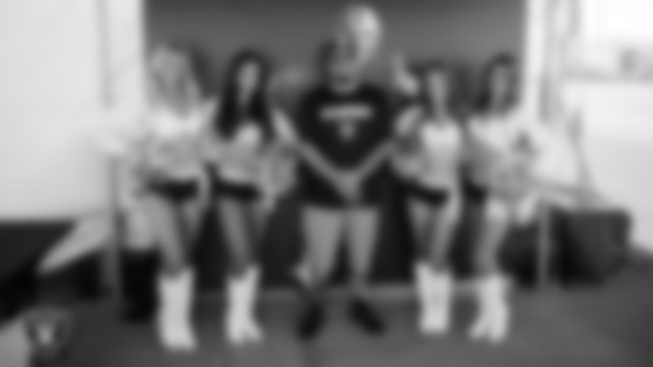 The Raiderettes pose for a photo with a fan during a 2025 Training Camp practice at Intermountain Health Performance Center.