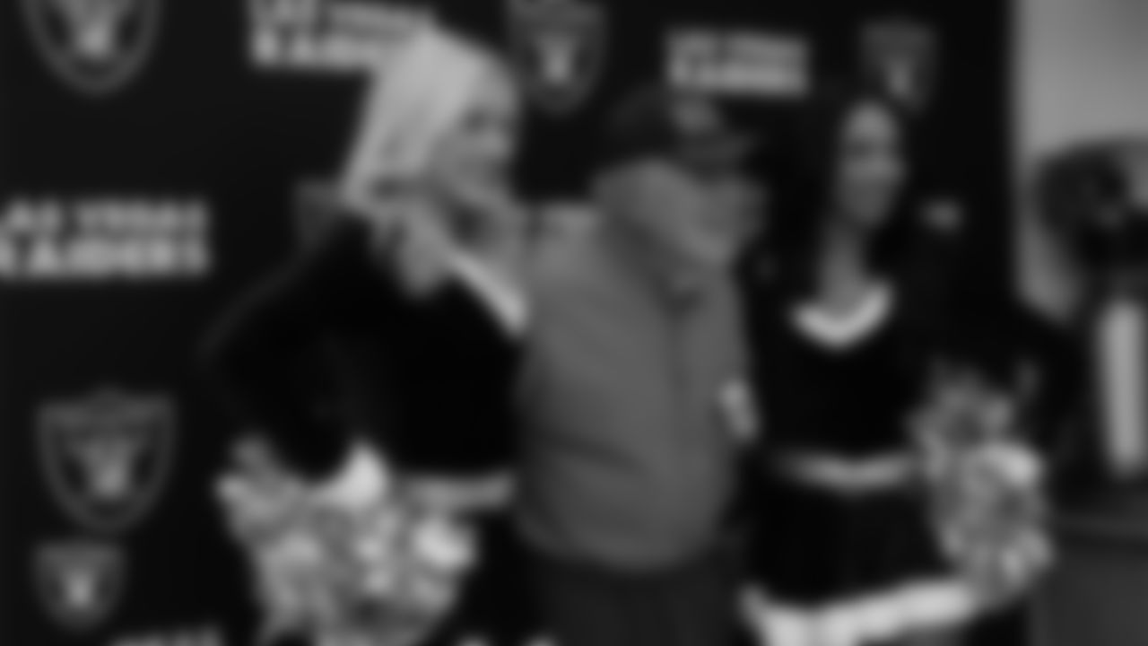 Raiderettes Kennedy and Cierra pose for a photo with a veteran during the annual Cox Salute to Service Tailgate at Southern Nevada State Veterans Home.