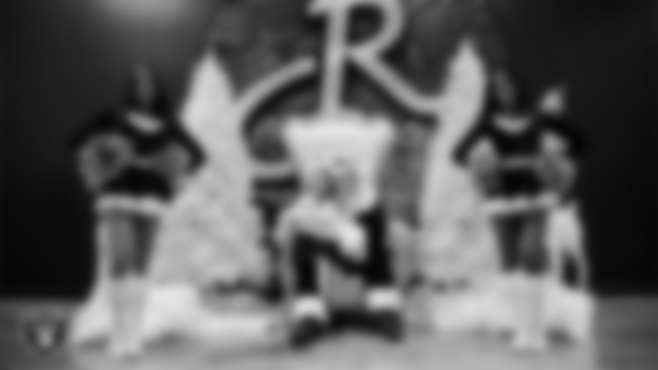 A Junior Raiderette poses for a photo with Santa during the Junior Raiderettes Banquet at The Studio.