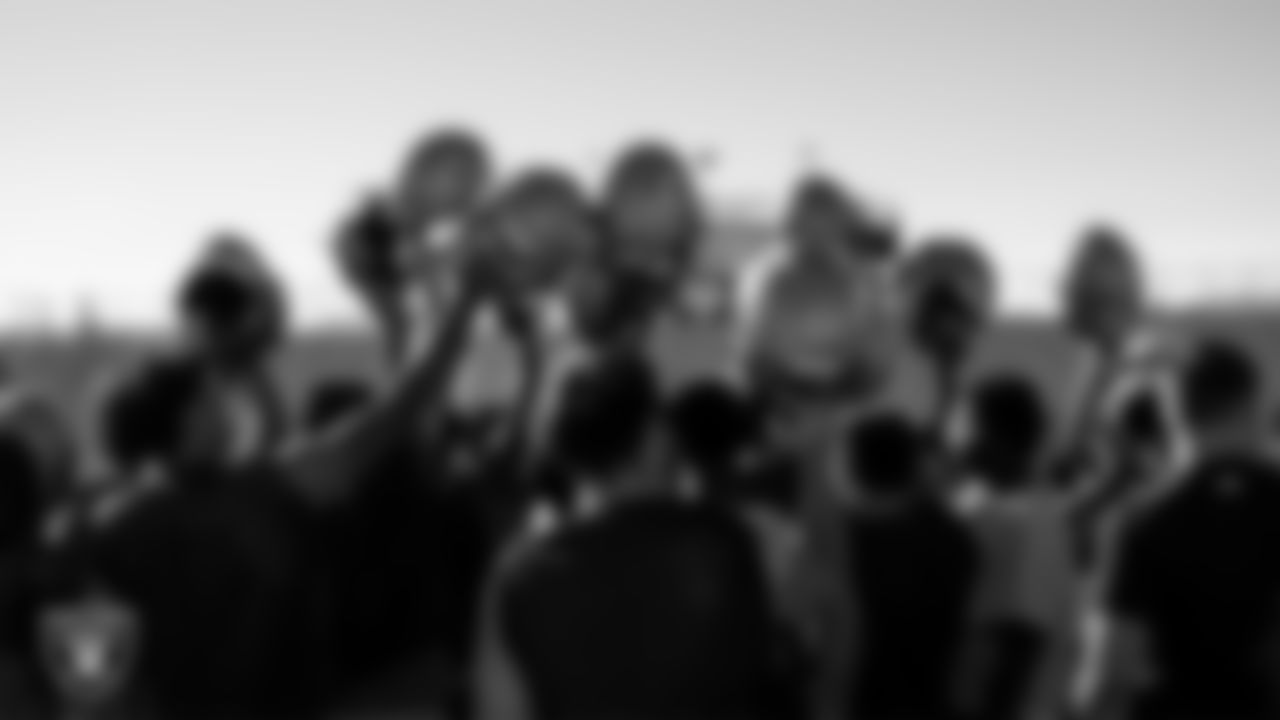 The Spring Valley High School football team huddles during practice at Spring Valley High School.