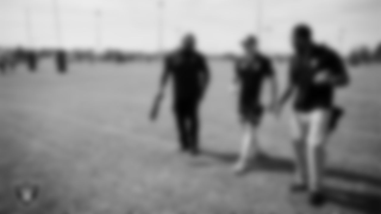 Las Vegas Raiders alumni Roy Hart and Korey Toomer talk with St. George Illawarra Dragons second-row forward Dylan Egan during the NRL Gala Day flag football tournament at Silver Bowl Park.