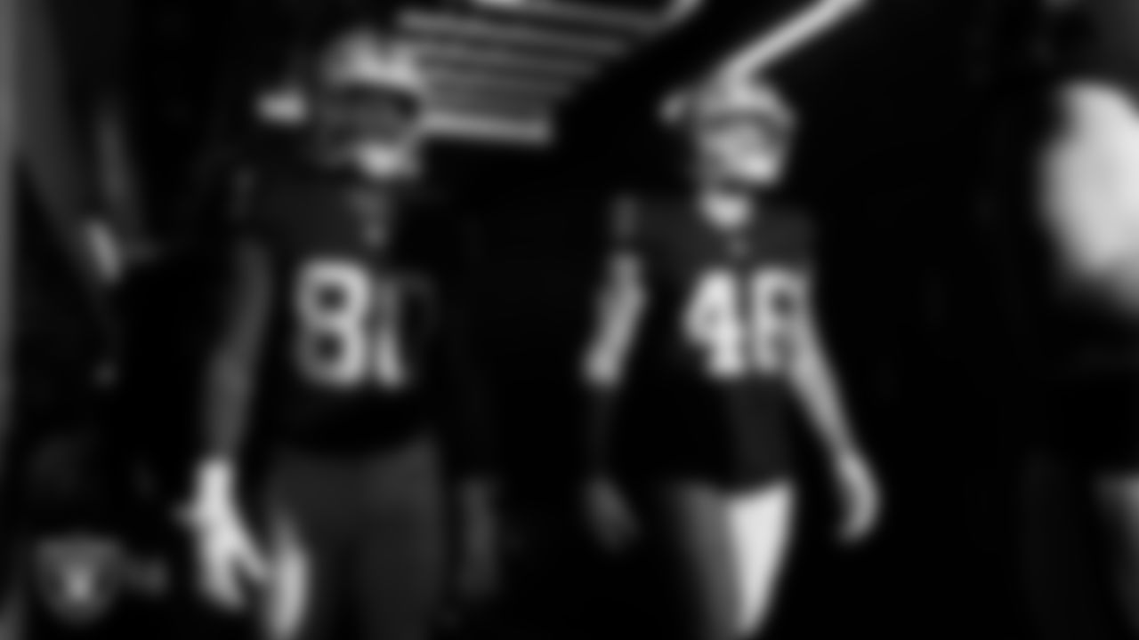 Las Vegas Raiders tight end Ian Thomas (80) and tight end Carter Runyon (46) walk down the tunnel before the regular season home game against the Tennessee Titans at Allegiant Stadium.