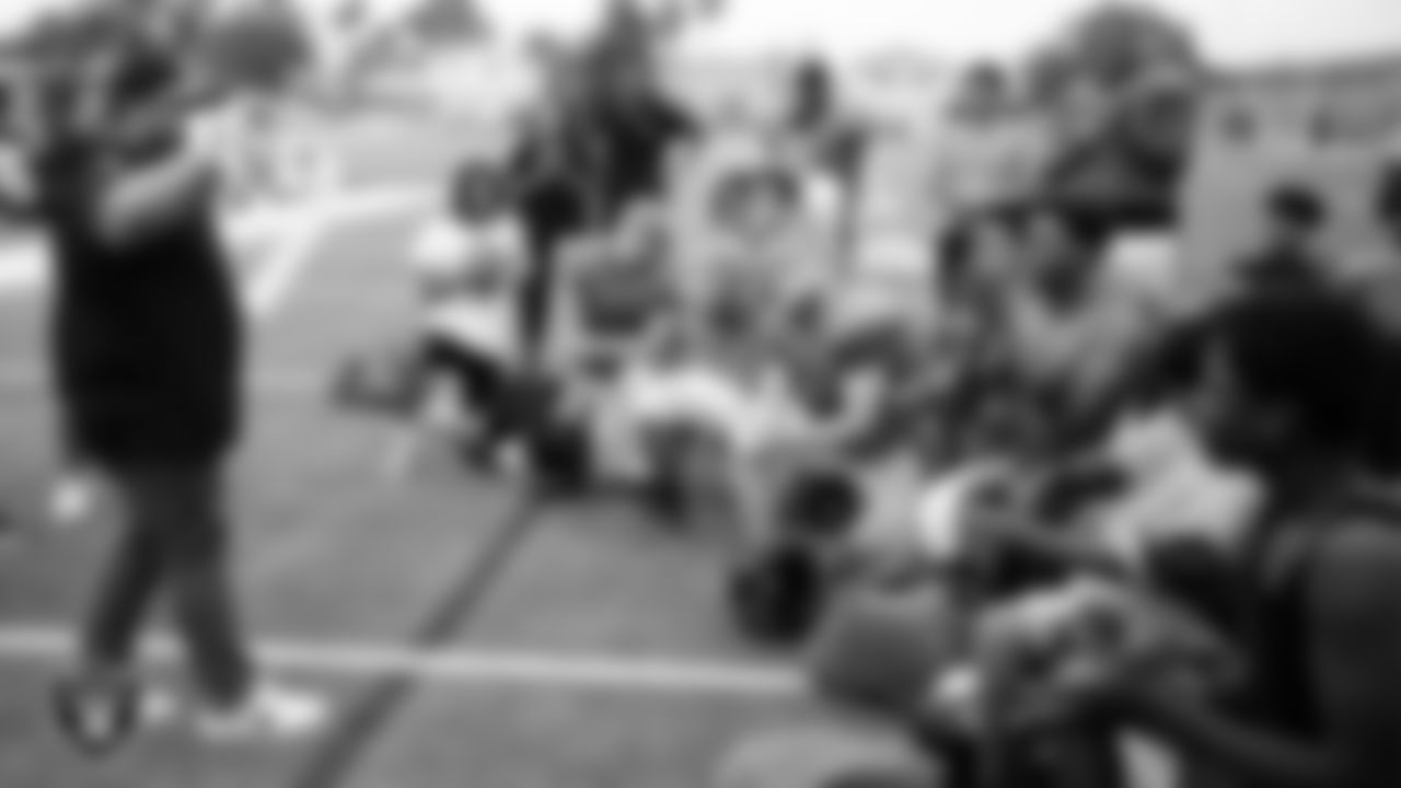 Las Vegas Raiders senior manager for football development Jordan Aguilar shows of the championship belt to the Chaparral High School football team during practice at Chaparral High School.