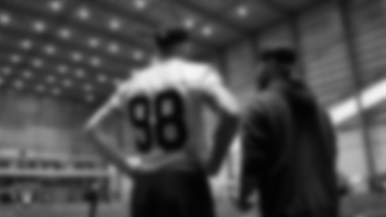 Las Vegas Raiders defensive end Maxx Crosby (98) and run game coordinator/defensive line coach Rob Leonard during practice at Intermountain Health Performance Center.