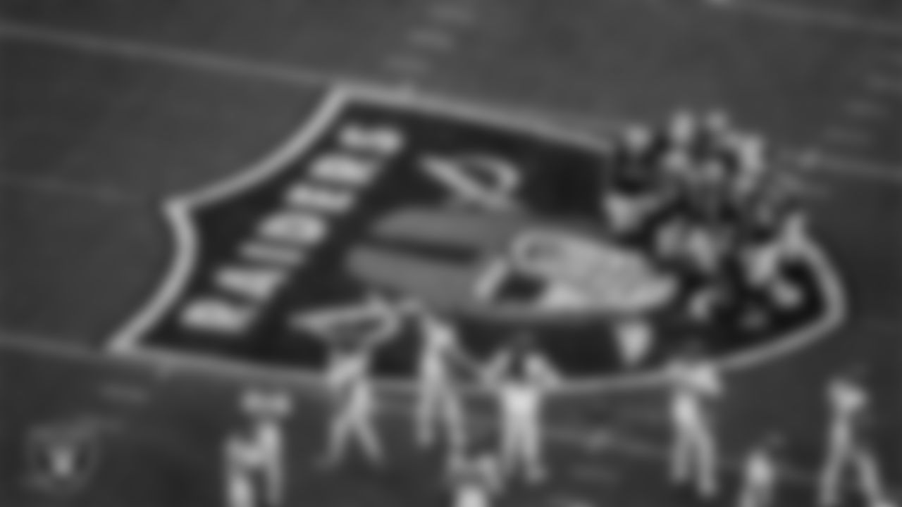 The Las Vegas Raiders huddle during the regular season home game against the Denver Broncos at Allegiant Stadium.