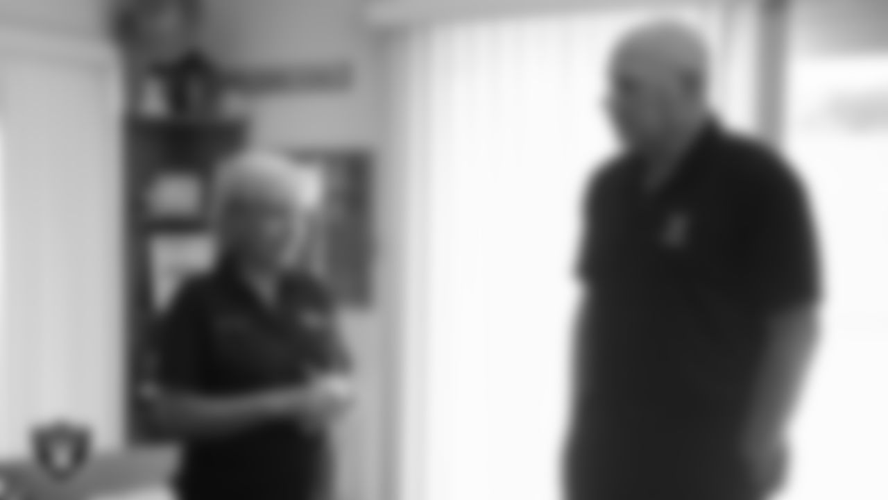 United States Air Force Veteran Bobi Oates speaks with Las Vegas Raiders alumnus Jay Schroeder after being surprised with tickets to the Raiders' Salute to Service game.