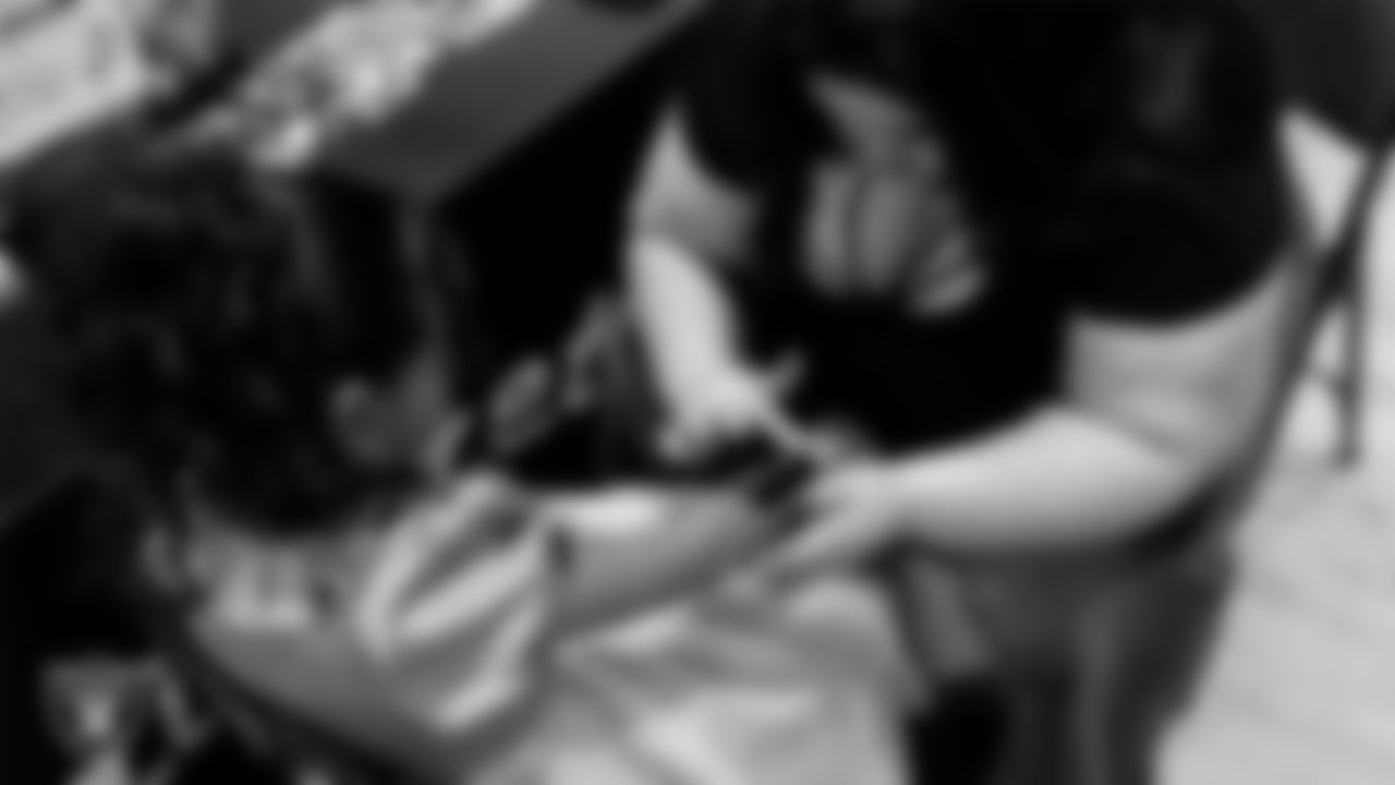 An attendee gets an airbrush tattoo during the Valentine's Day Dance at The Studio.