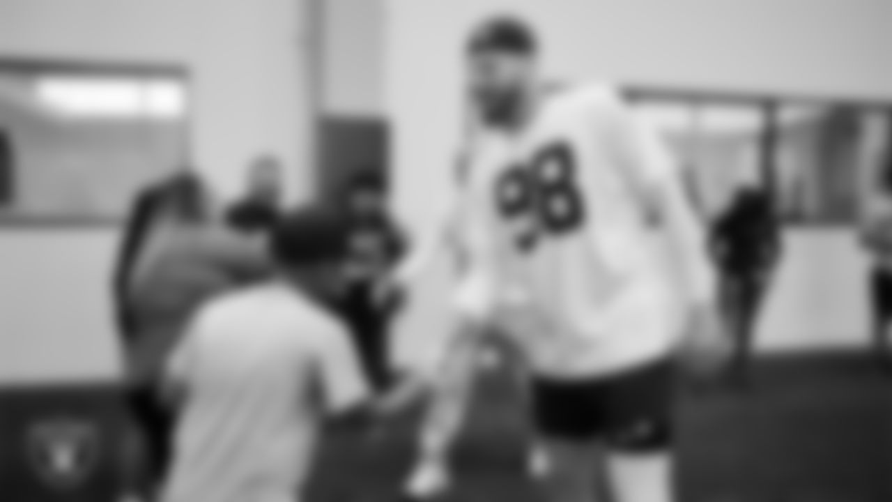 Christopher Arias from Make-A-Wish with Las Vegas Raiders defensive end Maxx Crosby (98) during a visit to Intermountain Health Performance Center.