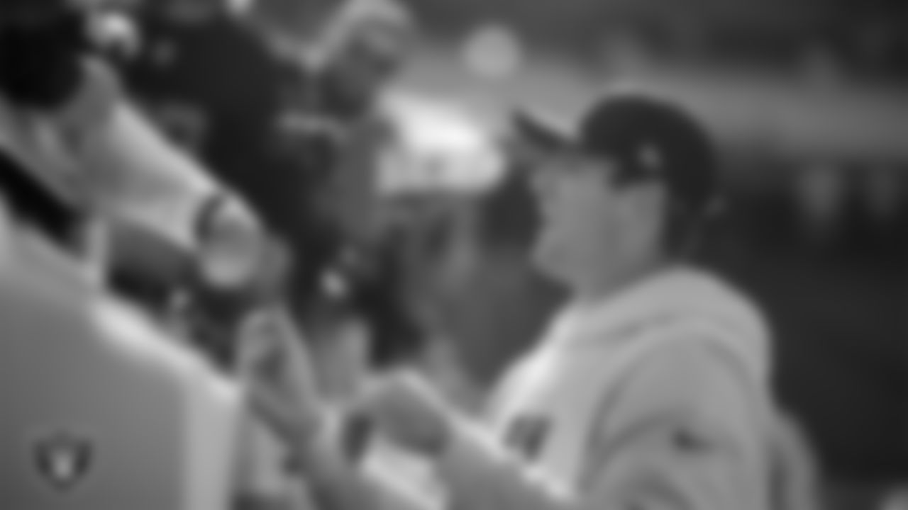 Las Vegas Raiders tight end Brock Bowers (89) signs autographs for fans before the regular season away game against the Kansas City Chiefs at GEHA Field at Arrowhead Stadium.