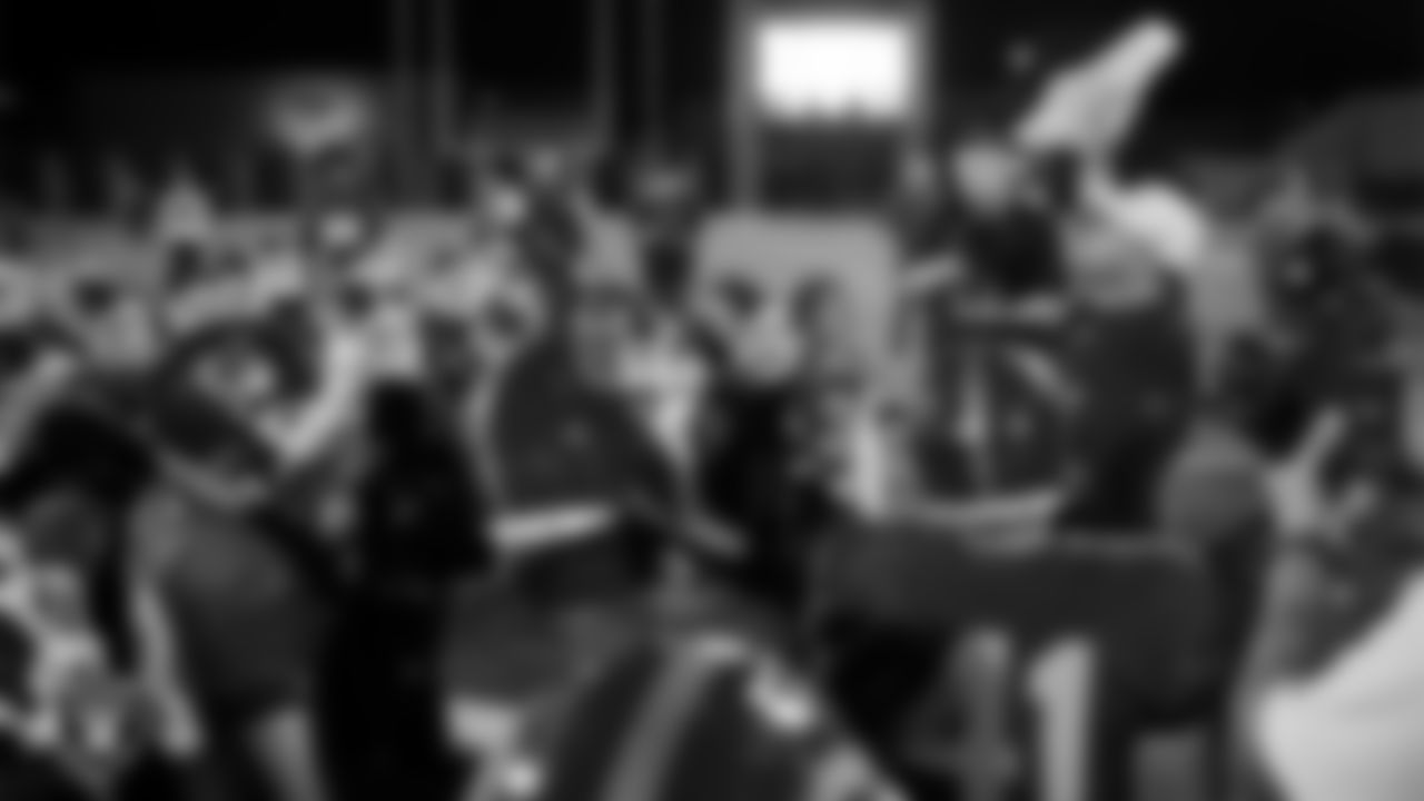 Las Vegas Raiders senior manager of football development Jordan Aguilar presents the championship belt to Bishop Gorman High School after the Las Vegas Raiders' Football Showcase game at Bishop Gorman High School.