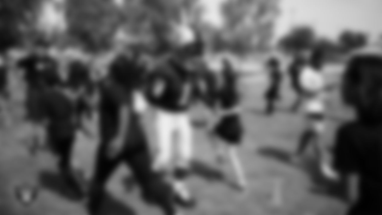 Raider Rusher high-fives students during a Raiders Junior Training Camp at Berkeley Bunker Elementary School.