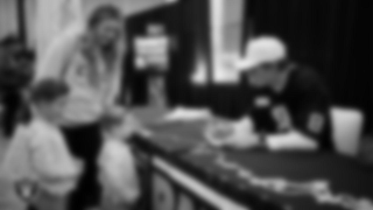 Las Vegas Raiders kicker Daniel Carlson (8) signs autographs for children of a service member at Nellis Air Force Base.