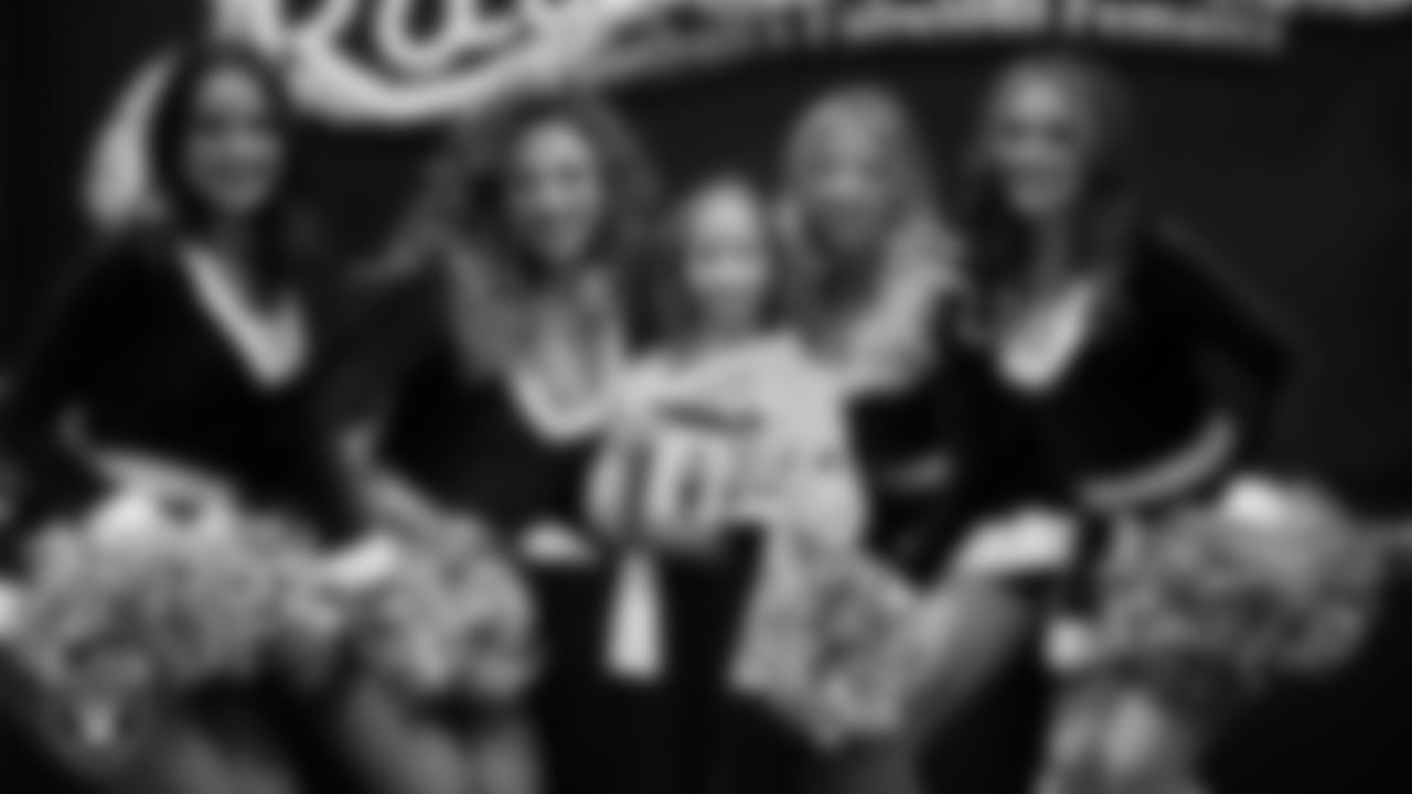 Raiderettes pose for a photo with a Junior Raiderette during the Junior Raiderettes Banquet at The Studio.