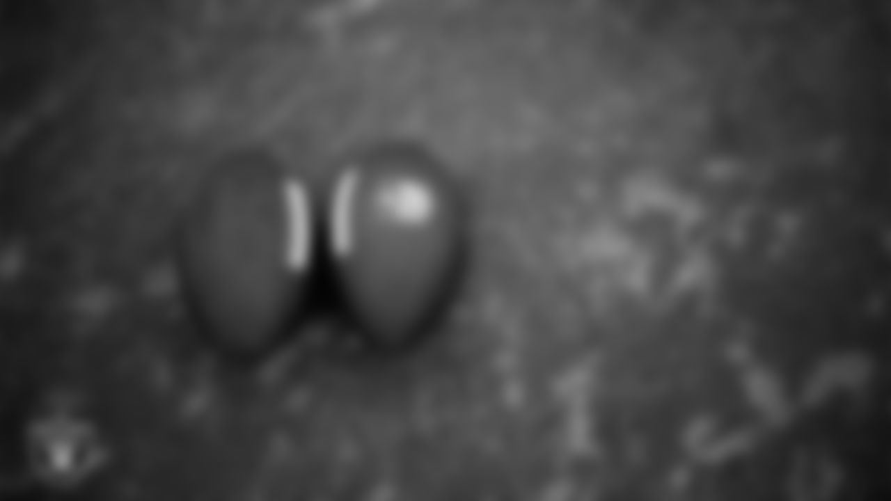 Footballs on the field during practice at Intermountain Health Performance Center.