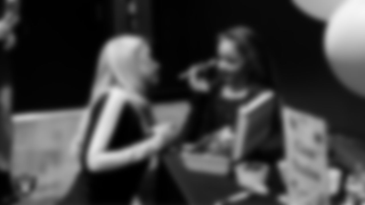 Raiderette Delaney does an attendee's makeup during the Valentine's Day Dance at The Studio.