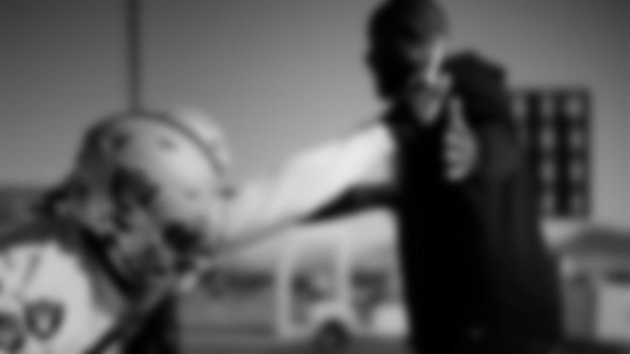 Las Vegas Raiders defensive end Malcolm Koonce (51) and assistant defensive line coach Kenyon Jackson during practice at Intermountain Health Performance Center.