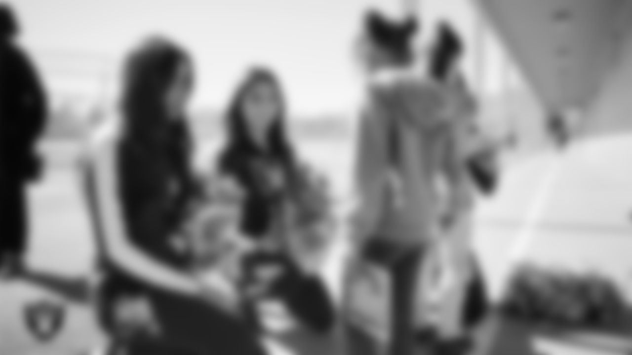 Raiderettes Meekela and Maddie speak with a student during Nevada Reading Week at Robert Taylor Elementary School.