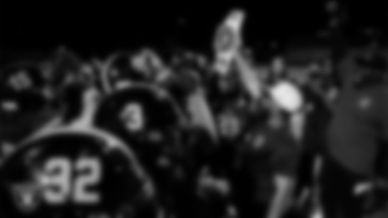 Las Vegas Raiders coordinator of football development Chris Shelby presents the championship belt to the Clark High School football team after the Raiders' Football Showcase game at Clark High School.