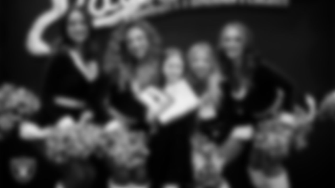 Raiderettes pose for a photo with a Junior Raiderette during the Junior Raiderettes Banquet at The Studio.