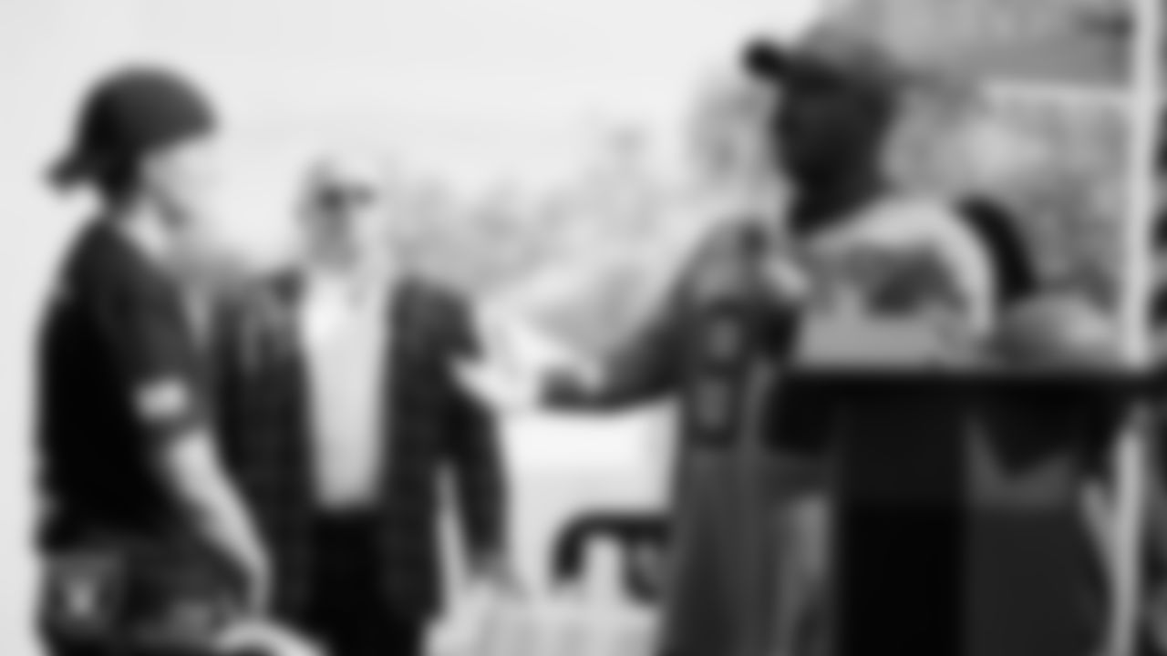 Las Vegas Raiders facilities manager and chief engineer Najja Williams speaks to a U.S VETS veteran during the Veterans Tailgate in Downtown Las Vegas.